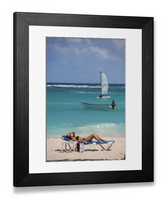 Framed Print : Dominican Republic, Punta Cana, Higuey, Bavaro, Bavaro Beach, young woman sunbathing