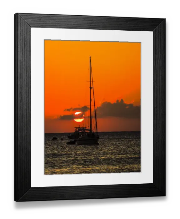 Framed Print : Seven Mile Beach, Grand Cayman. Sailboat and a boat with the orange sun setting behind Framed Print : Seven Mile Beach, Grand Cayman. Sailboat and a boat with the orange sun setting behind