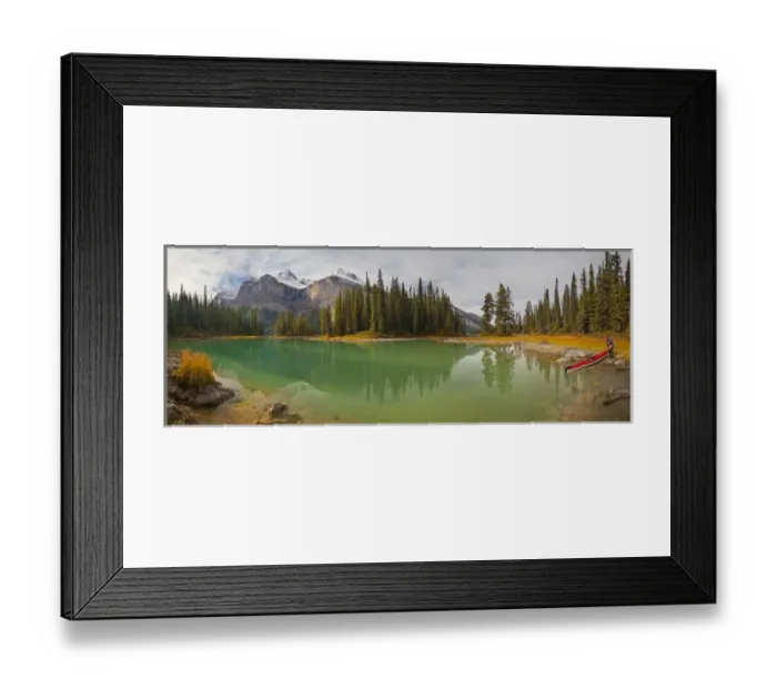 Framed Print : Canada, Alberta, Jasper National Park. A male sea kayaker launches a kayak on Maligne Lake Framed Print : Canada, Alberta, Jasper National Park. A male sea kayaker launches a kayak on Maligne Lake