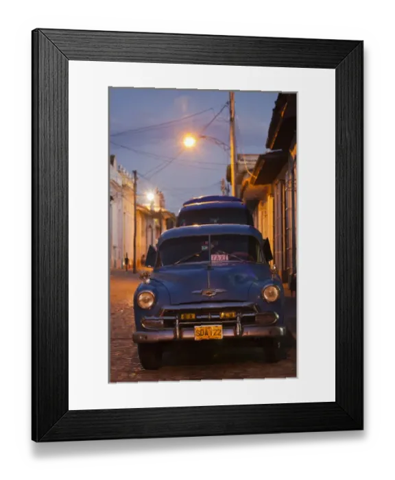 Framed Print : Cuba, Sancti Spiritus Province, Trinidad, taxis on Calle Antonio Maceo, dusk