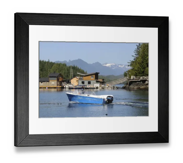 Framed Print : Vancouver Island, Tofino. Motorboat passing in front of floating houses