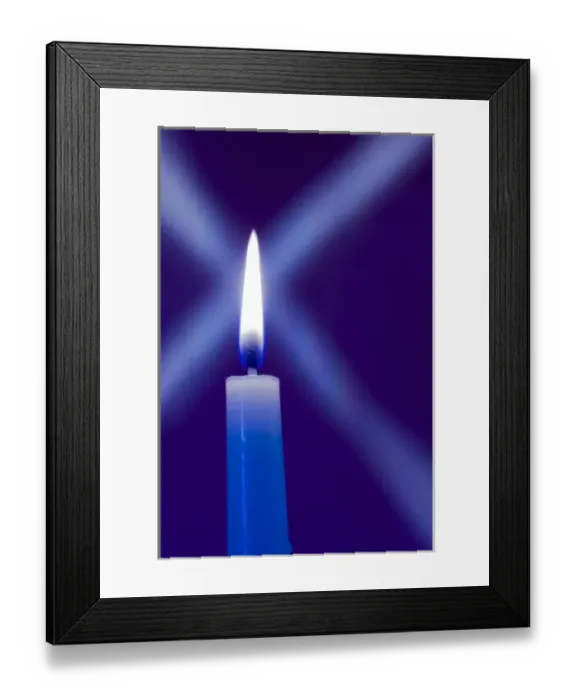 Framed Print : Burning candle with star burst on blue background