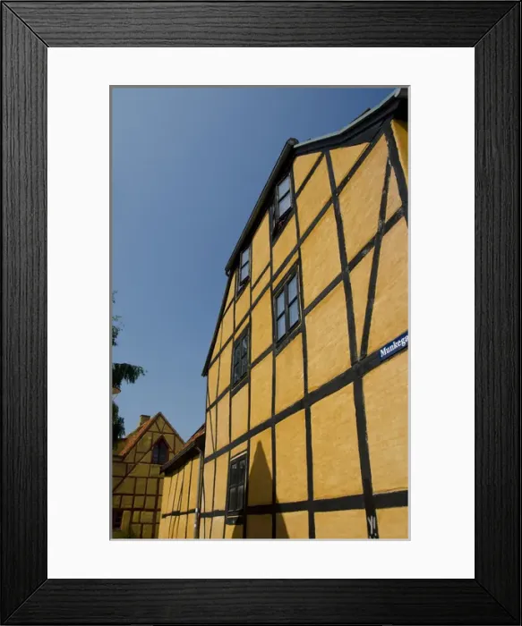 Framed Print : Denmark, Helsingoer. Traditional historic half-timbered architecture, colorful homes