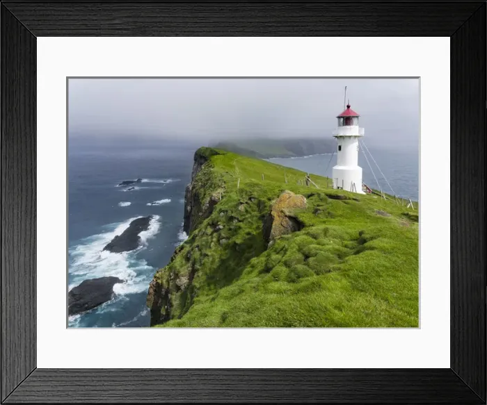 Framed Print : The lighthouse on Mykinesholmur. The island Mykines, part of the Faroe Islands in Framed Print : The lighthouse on Mykinesholmur. The island Mykines, part of the Faroe Islands in
