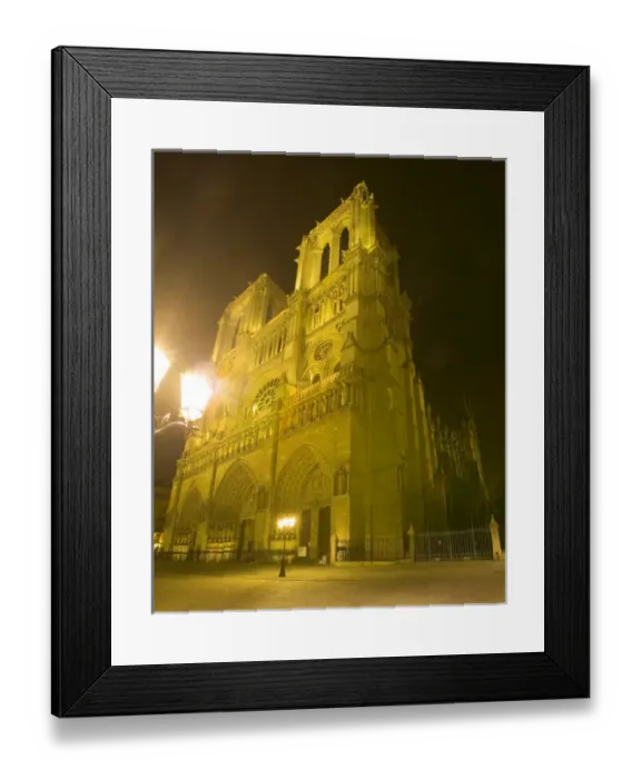 Framed Print : Europe, France, Paris. Exterior close-up of Notre Dame Cathedral lit at night. Credit as