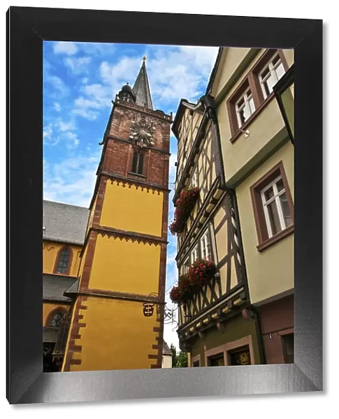 Wertheim, Franconia, Germany, A clock tower sits next to medieval Cross Timbered Houses