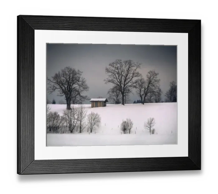Framed Print : Winter scene, hill and trees, hut and forboding sky Framed Print : Winter scene, hill and trees, hut and forboding sky