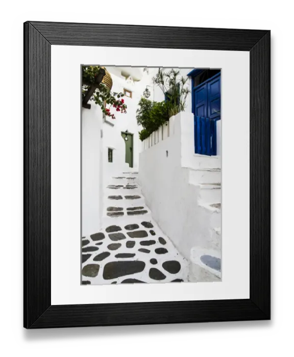 Framed Print : Mykonos, Greece. Rock and stucco patio and stairs leads to painted doors