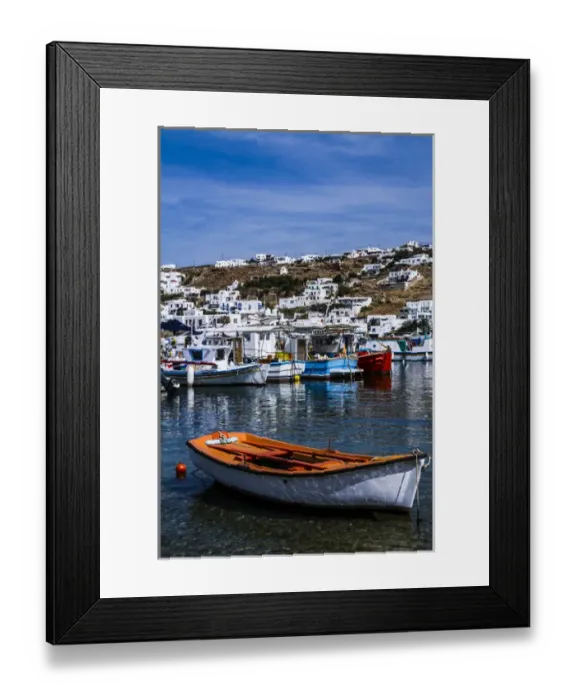 Framed Print : Mykonos, Greece. Orange and white boat floats in the water with other colorful boats Framed Print : Mykonos, Greece. Orange and white boat floats in the water with other colorful boats