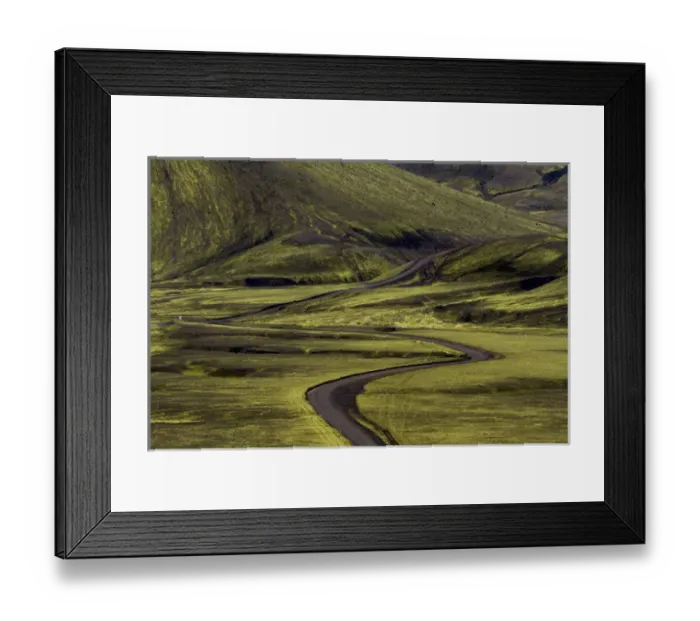 Framed Print : Europe, Iceland. Black dirt road curves through green countryside Framed Print : Europe, Iceland. Black dirt road curves through green countryside