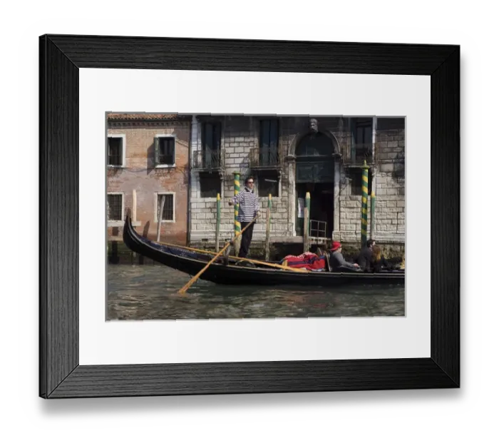 Framed Print : Europe, Italy, Venice. A gondolier strikes a pose on his gondola