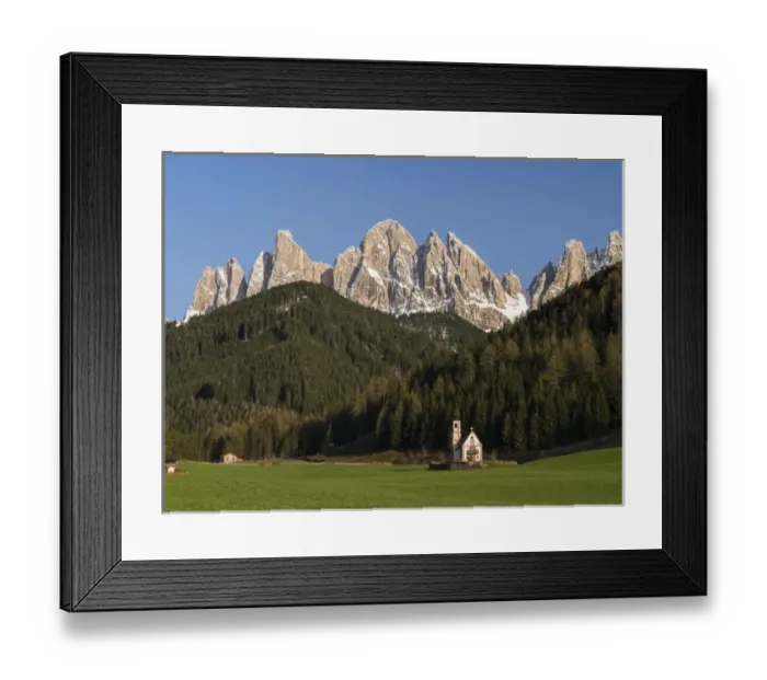 Framed Print : The peaks of the Geisler mountain range in valley Villnoess. The church Sankt Johann in Ranui (St