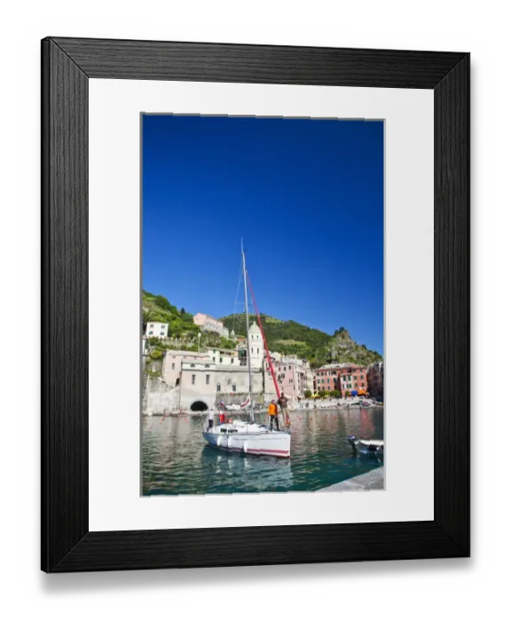 Framed Print : Europe; Italy; Vernazza; Sail Boat landing at the City and Church of Santa Margherita