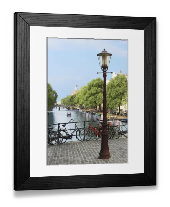 Framed Print : Amsterdam, Holland, Old gas lamp post and bicycles on a bridge over a canal in Framed Print : Amsterdam, Holland, Old gas lamp post and bicycles on a bridge over a canal in