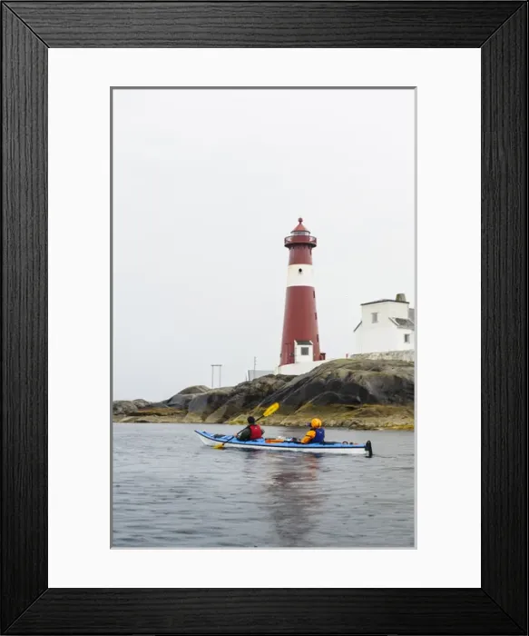 Framed Print : Norway, Nordland. Suzanne Spencer and Dylan McGuire sea kayaking past Trany light house