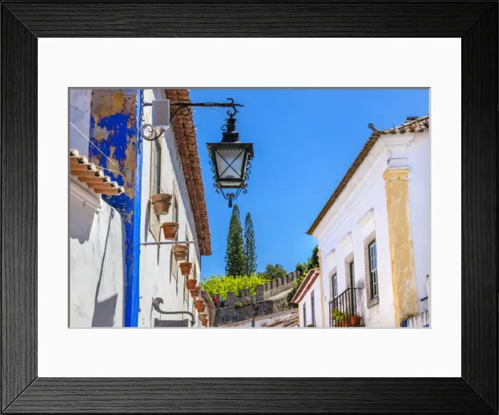 Framed Print : Narrow White Street 11th Century Castle Wall Medieval Town Lamp Obidos Portugal. Castle Framed Print : Narrow White Street 11th Century Castle Wall Medieval Town Lamp Obidos Portugal. Castle