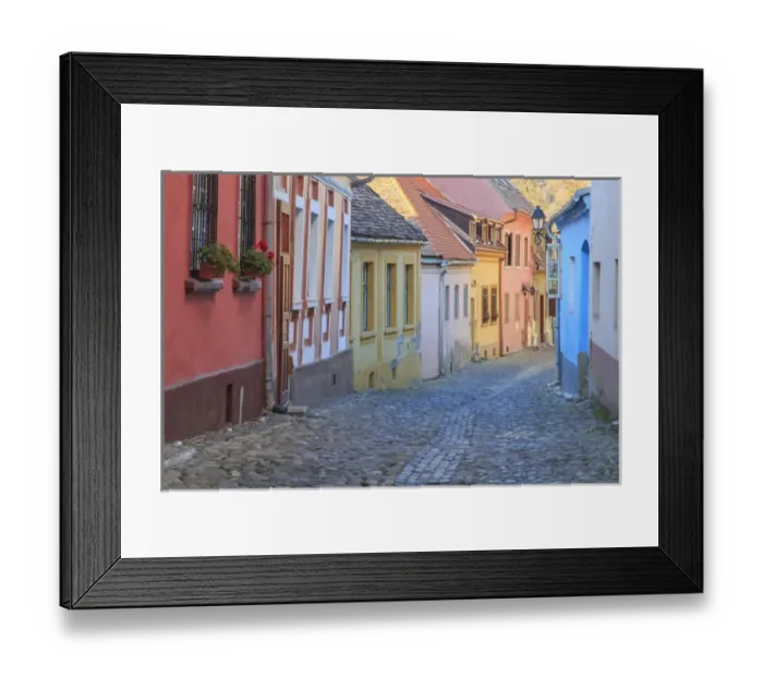 Framed Print : Europe, Romania, Sighisoara, cobblestone residential street of colorful houses in village Framed Print : Europe, Romania, Sighisoara, cobblestone residential street of colorful houses in village