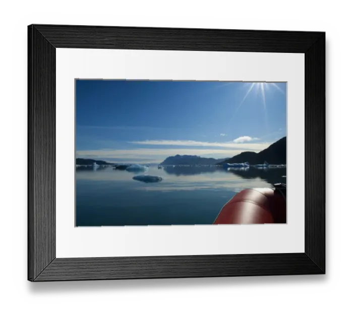 Framed Print : Greenland, Tunulliarfik Fjord. A rubber raft navigates through a sea of icebergs