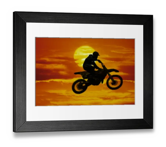 Framed Print : Digital composite of motocross racer doing jump in front of big sun Framed Print : Digital composite of motocross racer doing jump in front of big sun