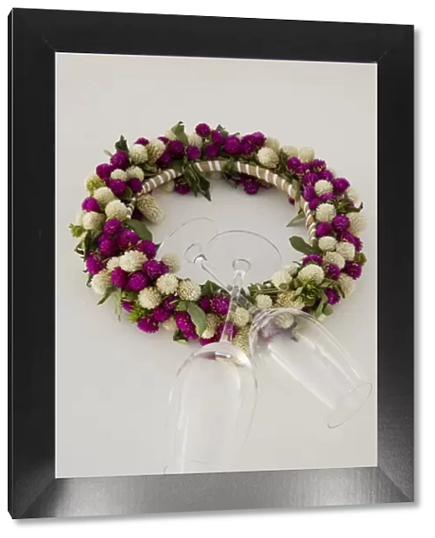 Oceania, French Polynesia, Taha a. Flower head wreath and wine glasses. Credit as