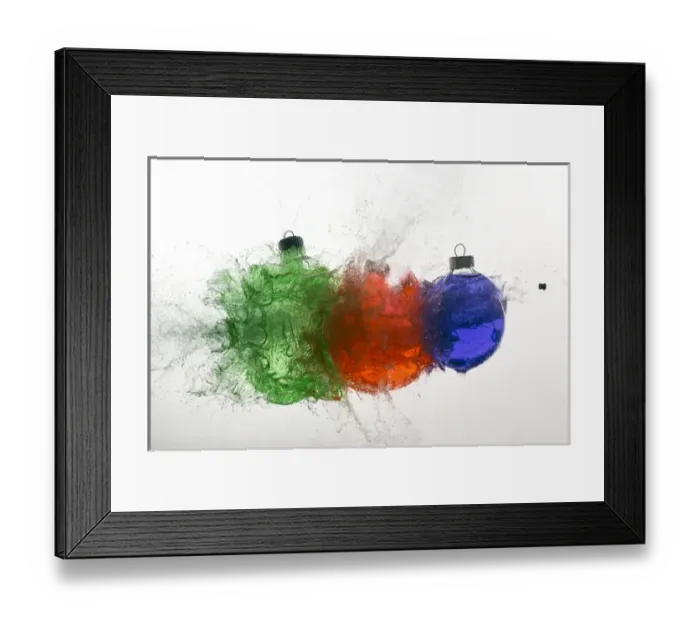 Framed Print : Stop action of Christmas ornaments filled with colored water and exploding form bullet