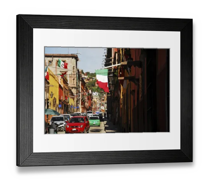 Framed Print : Mexico, San Miguel de Allende, flag flattering on buildings, car moving on street Framed Print : Mexico, San Miguel de Allende, flag flattering on buildings, car moving on street