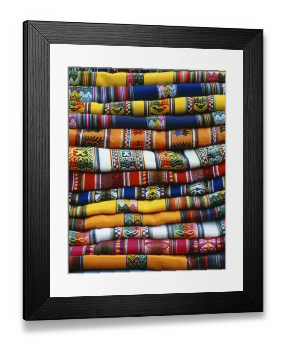 Framed Print : South America, Peru, near Cusco. Stack of colorful blankets for sale in market. Credit as