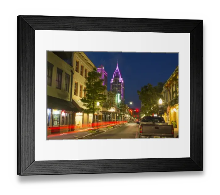 Framed Print : Mobile Alabama downtown traffic on Dauphin Street at twilight with Trustmark Skyscrapper Framed Print : Mobile Alabama downtown traffic on Dauphin Street at twilight with Trustmark Skyscrapper