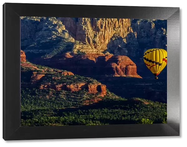 USA, Arizona. Hot-air balloon floats over Red Rocks State Park at sunset. Credit as