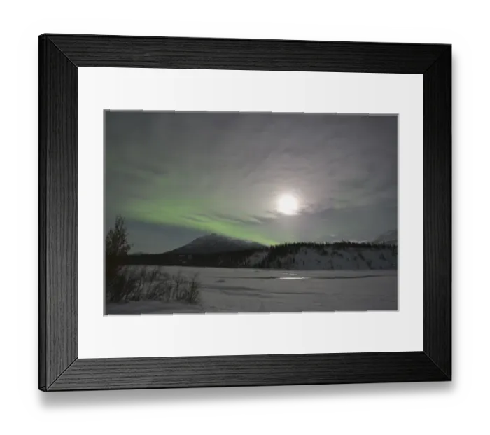 Framed Print : The moon rises over a curtain of green aurora borealis shimmering over the Middle