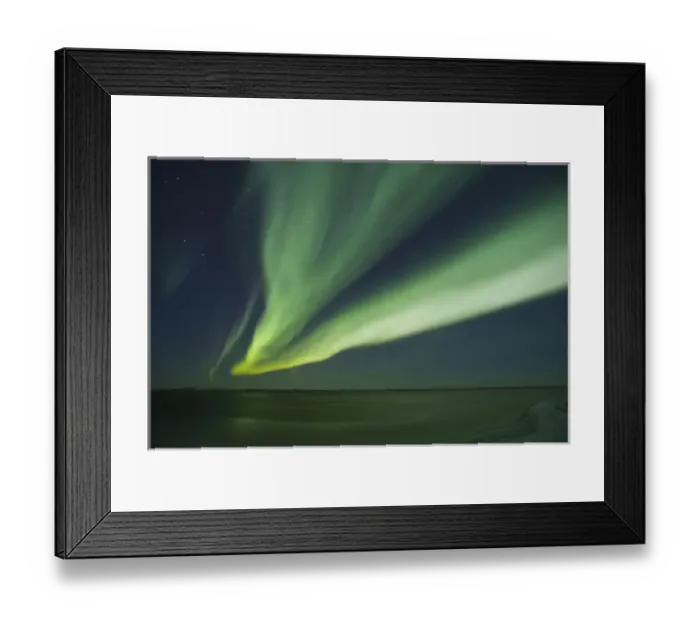 Framed Print : Shimmering curtains of green Aurora borealis dance in the southern sky over a lagoon Framed Print : Shimmering curtains of green Aurora borealis dance in the southern sky over a lagoon