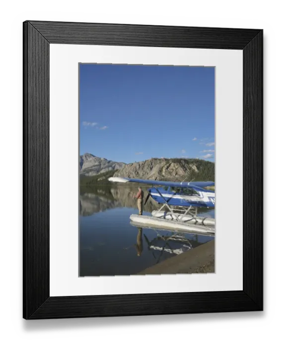 Framed Print : A fisherman casts for lake trout from a floatplane in scenic Takahula Lake located Framed Print : A fisherman casts for lake trout from a floatplane in scenic Takahula Lake located