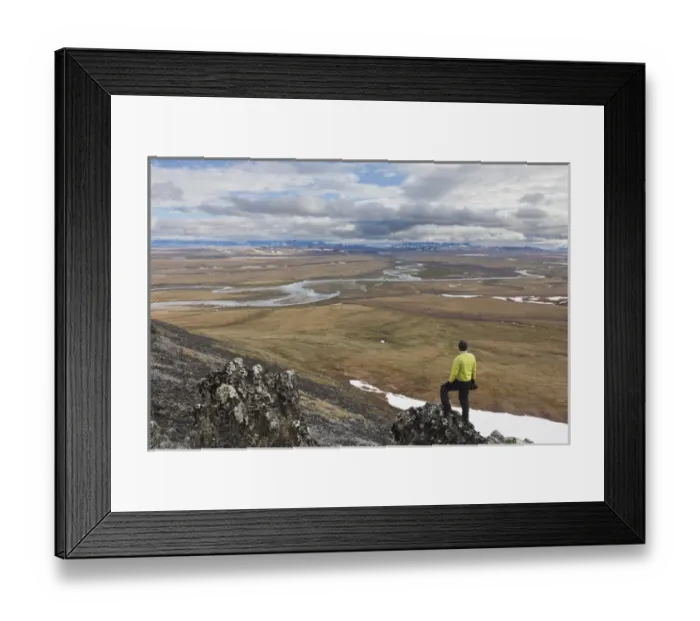 Framed Print : A hiker looks over the confluence of the Nigu and Etivlik Rivers near the base of
