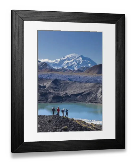Framed Print : A group of hikers stand on moraine next to a glacial meltpond at the edge of the Muldrow Glacier Framed Print : A group of hikers stand on moraine next to a glacial meltpond at the edge of the Muldrow Glacier