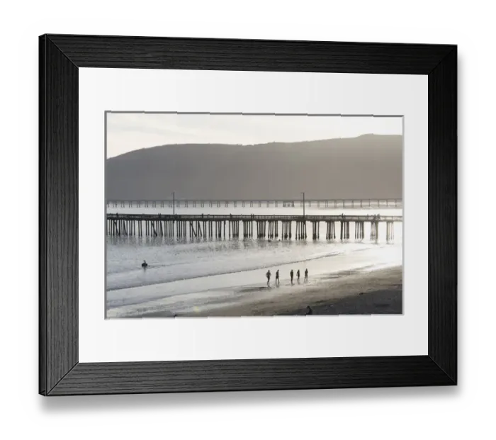 Framed Print : US, CA, Avila Beach. Silhouetted beach walkers approach pier end of day