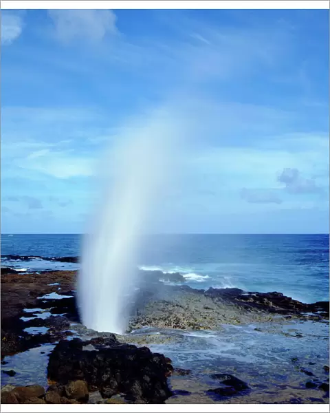USA; Kauai Hawaii; A blow hole spouts seawater on Kauai