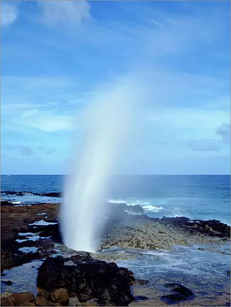 USA; Kauai Hawaii; A blow hole spouts seawater on Kauai