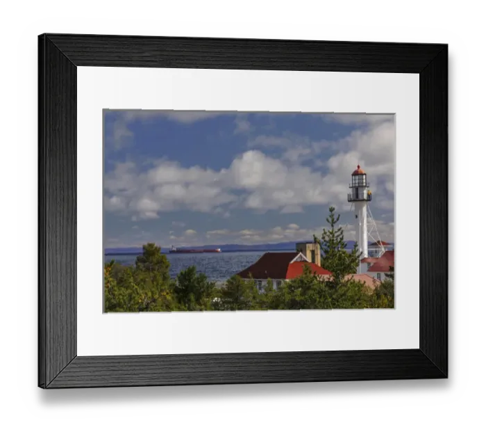 Framed Print : Freighter bound for Canada passing Whitefish Point Lighthouse, the oldest operating Framed Print : Freighter bound for Canada passing Whitefish Point Lighthouse, the oldest operating