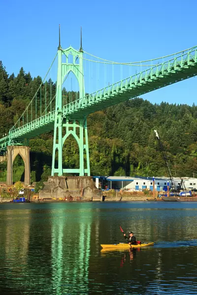 USA, Oregon, Portland, Cathedral Park, kayaker paddling under the St. Johns Bridge