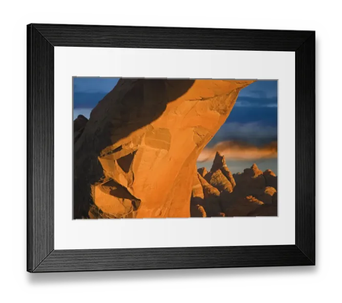 Framed Print : USA, Utah, Arches National Park. Setting sun illumines Skyline Arch, boulders, and spiral cloud Framed Print : USA, Utah, Arches National Park. Setting sun illumines Skyline Arch, boulders, and spiral cloud