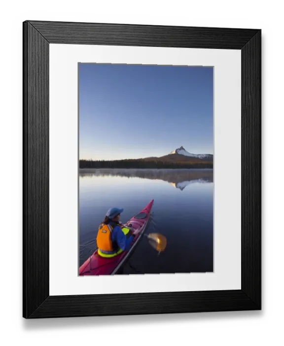 Framed Print : USA, Oregon. A woman in a sea kayak paddles at dawn on Big Lake, Oregon, in the Oregon Cascades Framed Print : USA, Oregon. A woman in a sea kayak paddles at dawn on Big Lake, Oregon, in the Oregon Cascades