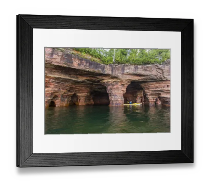 Framed Print : Kayaker exploring the sea caves of Devils Island in the Apostle Islands National Lakeshore