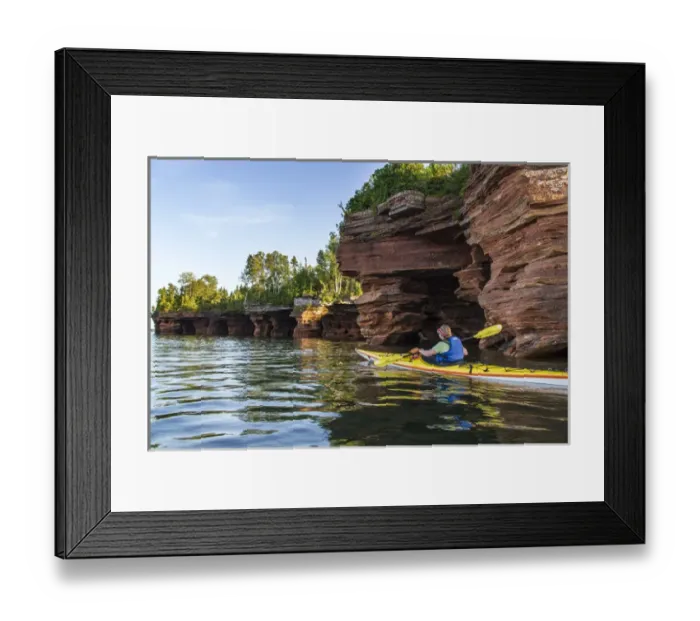 Framed Print : Kayaker exploring the sea caves of Devils Island in the Apostle Islands National Lakeshore