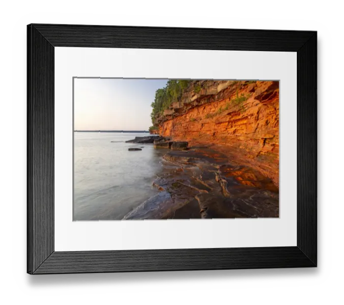 Framed Print : Layered sandstone cliffs and sea caves at sunrise on Devils Island in the Apostle Framed Print : Layered sandstone cliffs and sea caves at sunrise on Devils Island in the Apostle