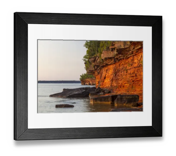 Framed Print : Layered sandstone cliffs and sea caves at sunrise on Devils Island in the Apostle Framed Print : Layered sandstone cliffs and sea caves at sunrise on Devils Island in the Apostle