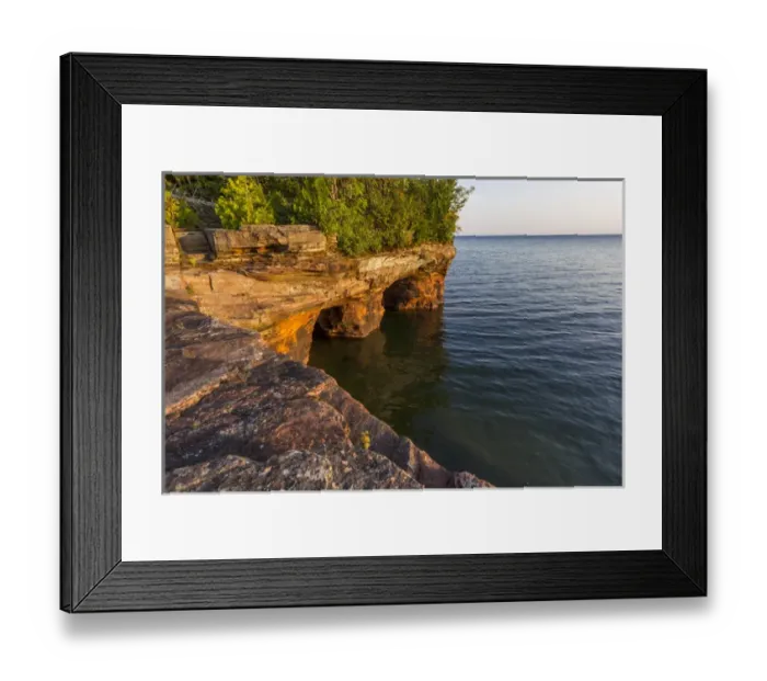 Framed Print : Layered sandstone cliffs and sea caves at sunrise on Devils Island in the Apostle Framed Print : Layered sandstone cliffs and sea caves at sunrise on Devils Island in the Apostle