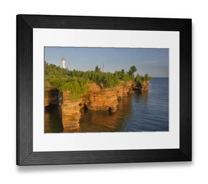 Framed Print : Layered sandstone cliffs and sea caves at sunrise on Devils Island Lighthouse in