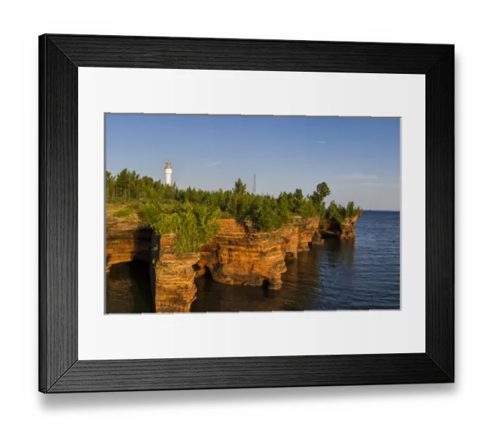 Framed Print : Layered sandstone cliffs and sea caves at sunrise on Devils Island Lighthouse in