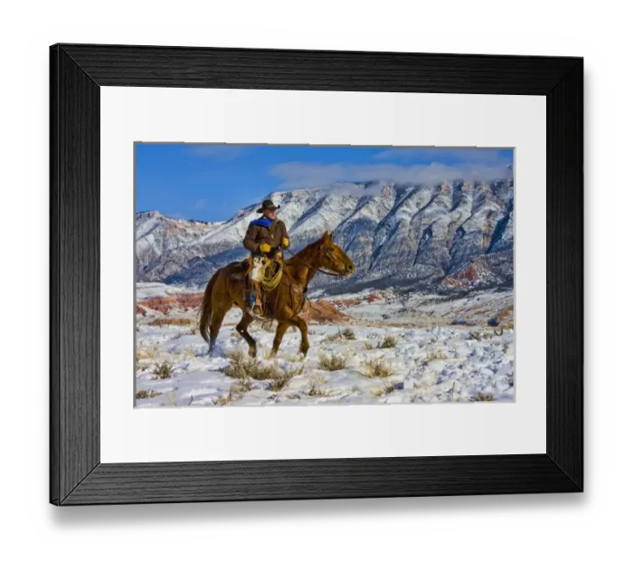 Framed Print : North America; USA; Wyoming; Shell; Cowboy riding Horse through the Snow; Model Released