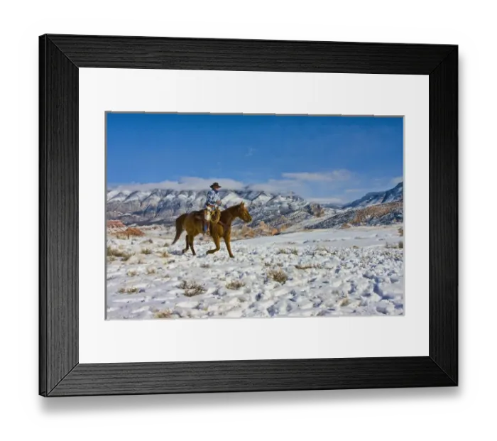 Framed Print : North America; USA; Wyoming; Shell; Cowboy riding Horse through the Snow; Model Released Framed Print : North America; USA; Wyoming; Shell; Cowboy riding Horse through the Snow; Model Released
